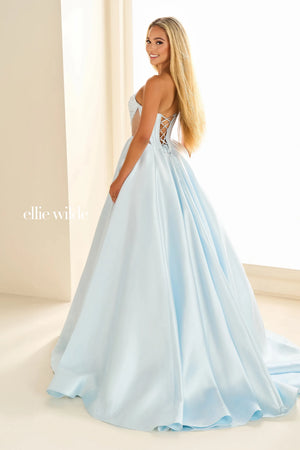 Feel like Cinderella in this dreamy A line dress by Ellie Wilde, style EW36025. Featuring a breathtaking strapless and V neckline with a key hold cut in the center. The side cut out give a beautiful silhouette as well as the corset lace up. The best part about this dress is the side pockets and detachable shoulder straps that are included. Twirl away in the voluminous skirt, making you the center of attention.