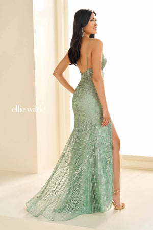 Feel like a princess when wearing this long fitted dress by Ellie Wilde, style EW36033. Showcasing a plunging v- neckline with delicate straps leading to a back zipper closure with see through tulle on the sides of the top that will hug you gorgeously. Fully embellished with cracked ice, glistening sequins and stunning beadwork throughout the dress. It also has a simple classy train.