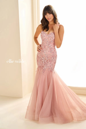 Have jaws on the floor when you make an entrance with this stunning dress by Ellie Wilde, style EW36060. The mermaid dress displays a sweetheart neckline supported with two dainty straps that lead to a corset lace up back. The bodice of this dress features an array of patterns displaying appliques and beading. The mermaid skirt and train is a change of scenery with glitter tulle, giving this dress a contrast of designs.