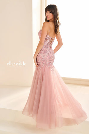 Have jaws on the floor when you make an entrance with this stunning dress by Ellie Wilde, style EW36060. The mermaid dress displays a sweetheart neckline supported with two dainty straps that lead to a corset lace up back. The bodice of this dress features an array of patterns displaying appliques and beading. The mermaid skirt and train is a change of scenery with glitter tulle, giving this dress a contrast of designs.