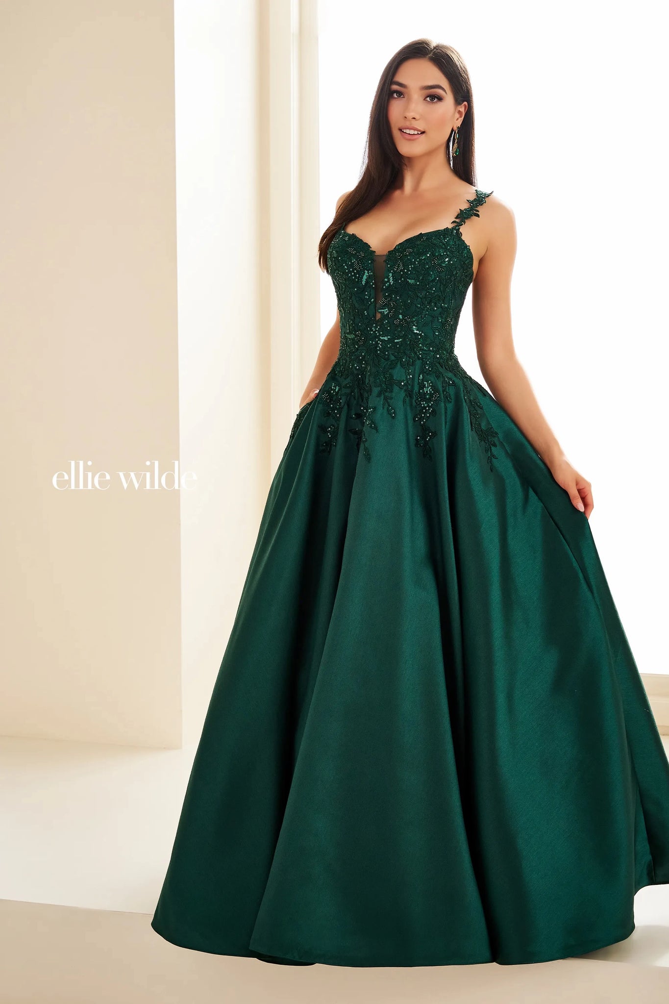 Have a memorable night in Ellie Wilde style EW36094 at your special event. This lovely A line dress showcases a modest v neckline with dainty floral shoulder straps. The fitted bodice is decorated with unique floral applique flowing into the full satin skirt ensuring you look and feel beautiful.