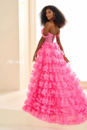 Show off your inner fashionista in this gorgeous A line dress from Ellie Wilde style EW36201. The corset structured bodice is made of sheer illusion with flower appliques adoring it. The ruffled layered aline skirt has a front thigh high side lit and a sweeping train. Included our separate straps to add to the strapless look.