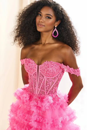 Show off your inner fashionista in this gorgeous A line dress from Ellie Wilde style EW36201. The corset structured bodice is made of sheer illusion with flower appliques adoring it. The ruffled layered aline skirt has a front thigh high side lit and a sweeping train. Included our separate straps to add to the strapless look.