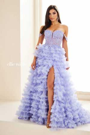 Show off your inner fashionista in this gorgeous A line dress from Ellie Wilde style EW36201. The corset structured bodice is made of sheer illusion with flower appliques adoring it. The ruffled layered aline skirt has a front thigh high side lit and a sweeping train. Included our separate straps to add to the strapless look.