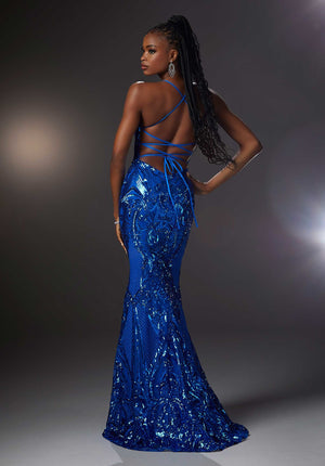 Make a statement at your senior prom in this stunning style 43032 by Morilee embellished completely with patterned sequins. This form fitting stellar gown showcases a V neckline with spaghetti straps on the open lace up tie back. The long body conscious skirt has a back sweep train.