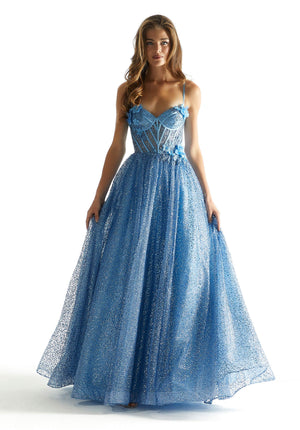 Live a modern day fairy tale at prom when you channel your inner princess and wear this spectacular long a line dress style 49001 from Morilee. This scintillating gown is made in layers of sequin tulle and sparkle tulle embellished with three dimensional flowers and sparking bead work. The sheer corset bodice showcases exposed boning, spaghetti straps and low zip up back. The a line, ball gown skirt flows beautifully to the floor with a sweep train.