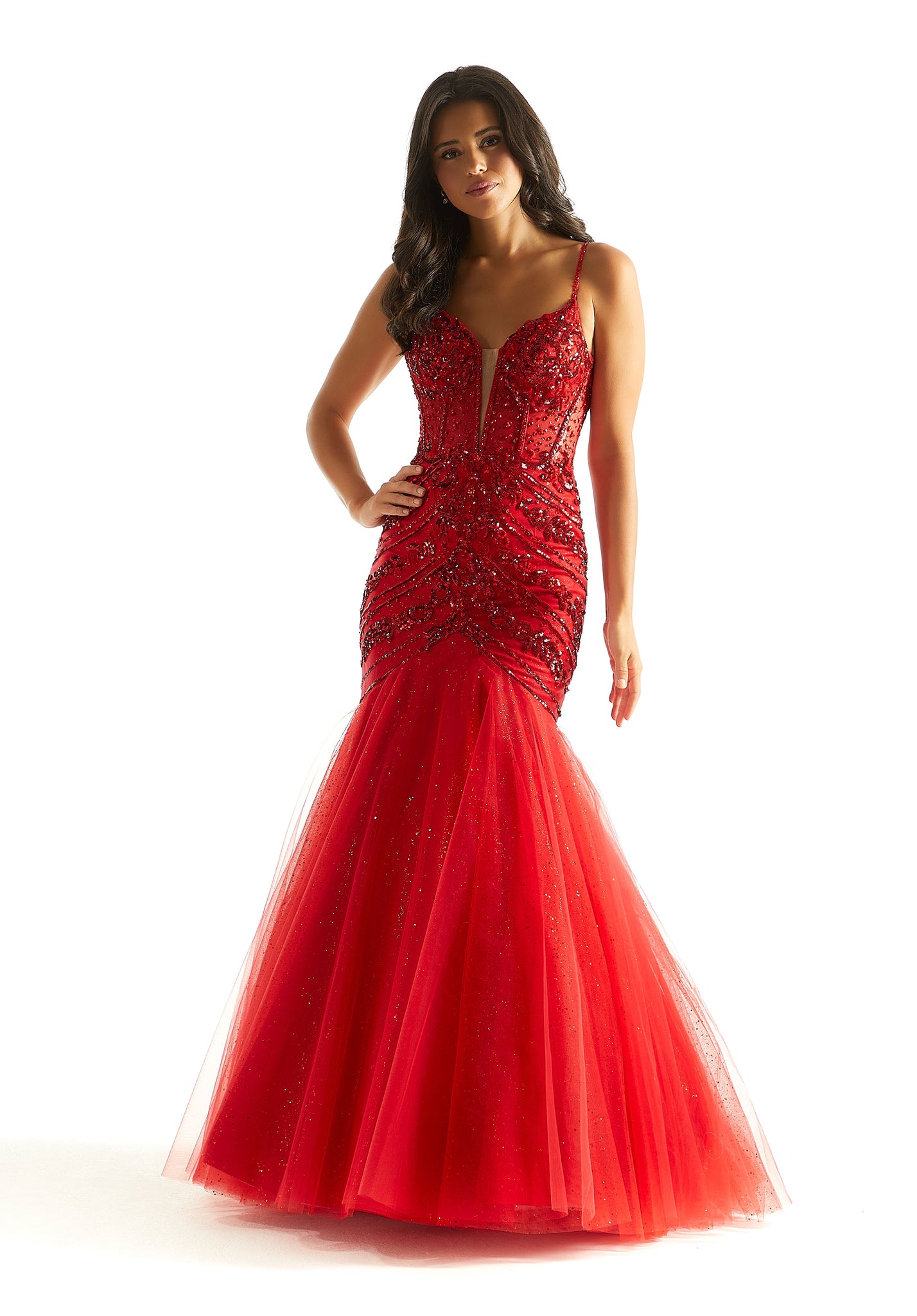 Feel classy and elegant in this magnificent long dress by Morilee, style 49014. Showcasing a mermaid silhouette with plunging v neckline that has mesh for q modest touch. This ensemble is adorned with glistening sequins and dazzling beadwork. The corset bodice is sure to hug your body gorgeously. The tulle skirt has glitter for a touch of sparkle.