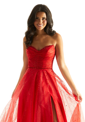 Dance the night away in this delightful Morilee dress 49028. This mesmerizing gown features a strapless sweetheart neckline and flattering a line silhouette. The ruche corset bodice accentuates your figure beautifully. Gleaming beads adorn the entire silhouette giving this gown the perfect pop of sparkle. Made in a playful tulle fabric, the a line skirt highlights a high slit that makes for a remarkable exit.