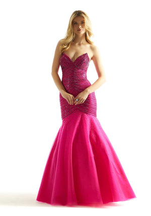 Red carpet ready this captivating Morilee dress 49029 will fascinate all in sight. Dynamic and astonishing, this sophisticated mermaid gown features a strapless sweetheart neckline. Flattering ruche detailing adorns the fitted dropped bodice is adorn in shimmering stones that give this gown the perfect pop of sparkle. Made in a charming tulle skirt features a full mermaid skirt that highlights an elaborate sweep train.
