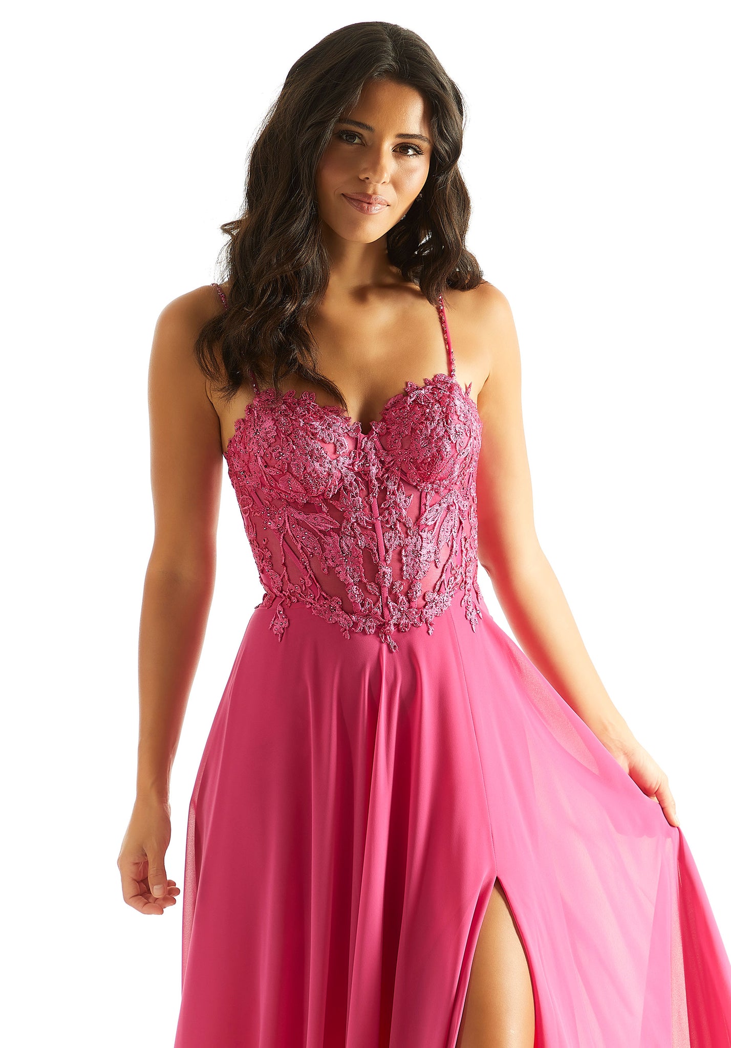 Exude confidence in this romantic and flattering Morilee A-line prom dress 49056. Ornate symmetrically sewn beaded appliques are featured symmetrically throughout the corset bodice that can be cinched and adjusted to your liking with the trendy corset lace up featured on the back. The flowy chiffon skirt features a thigh high slit with a sweep train.