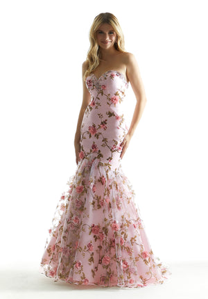This floral print 49067 Morilee dress exudes romance from top to bottom. Available in either a lovely pink or champagne color, this fitted dress is adorned in embroidered floral patterns and appliques that travel onto the organza mermaid sweep train while the garnished bodice shows a strapless sweetheart neckline along with the adjustable corset bodice on the back.