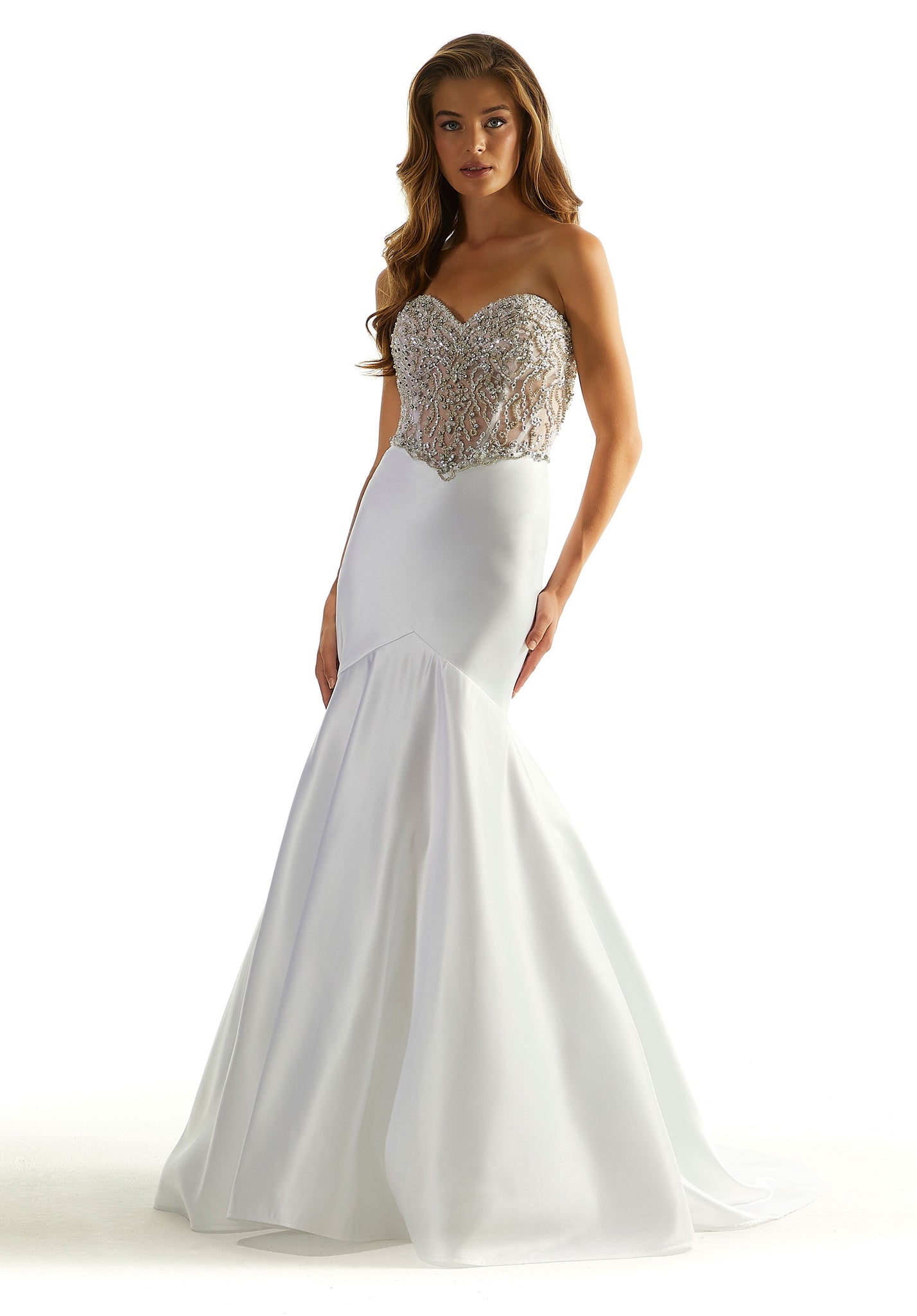 Feel elegant when wearing this beautiful long fitted mermaid dress by Morilee, style 49090. This number showcases a unique strapless sweetheart neckline with a full beaded see through corset top leading to a back zipper that will for sure hug your body beautifully. Featuring a satin skirt with ruching in the back. You will for sure look unqiue throughout the night.
