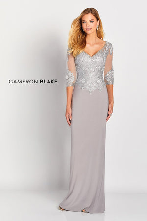This elegant jersey sheath with lace illusion three quarter sleeves features a beaded wide V-neckline, a dropped waist bodice adorned with stunning metallic lace applique'ss and beading, a beaded scoop back and a sweep train.  Sizes: 4-20   Available in Gold, Navy, Silver  If we do not have your desired size or color in stock please call or email us for availability!