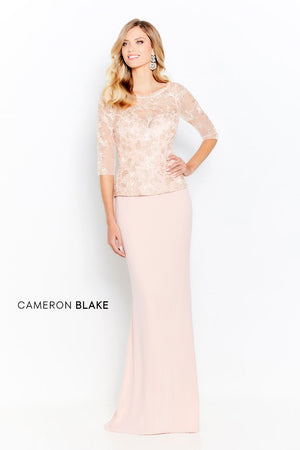 Sleeveless sheath gown, corded lace and sequin bodice with an illusion bateau neckline, natural waistline with a soft peplum, slim crepe skirt with sweep train. Separate three-quarter length sleeves included. (Pictured is Blush/Gold))  Sizes: 4-20, 16W-26W   Available in Navy, Blush/Gold  If we do not have your desired size or color in stock please call or email us for availability