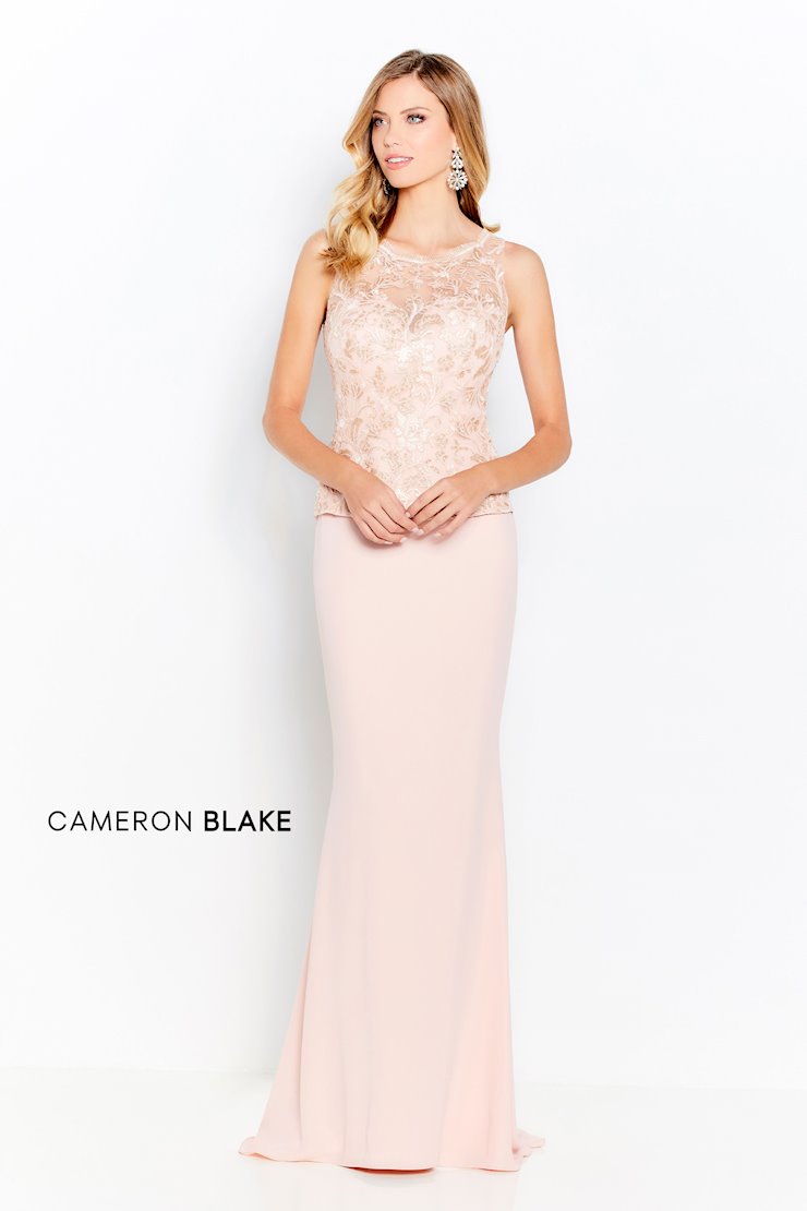 Sleeveless sheath gown, corded lace and sequin bodice with an illusion bateau neckline, natural waistline with a soft peplum, slim crepe skirt with sweep train. Separate three-quarter length sleeves included. (Pictured is Blush/Gold))  Sizes: 4-20, 16W-26W   Available in Navy, Blush/Gold  If we do not have your desired size or color in stock please call or email us for availability