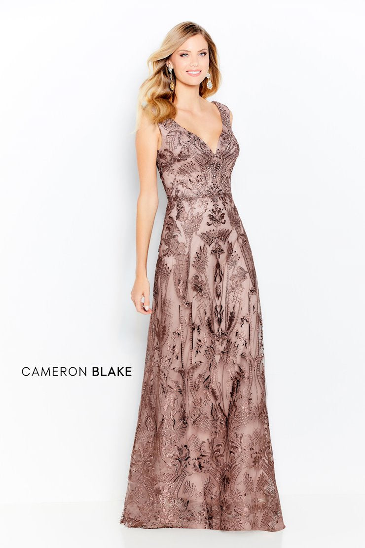 Sleeveless embroidered lace and tulle gown, curved V-neckline and back, delicate beaded bodice, natural waistline, a-line skirt. (Pictured: Coffee)  Sizes: 4-20  Available in Coffee, Blue Willow, Loden Green  If we do not have your desired size or color in stock please call or email us for availability
