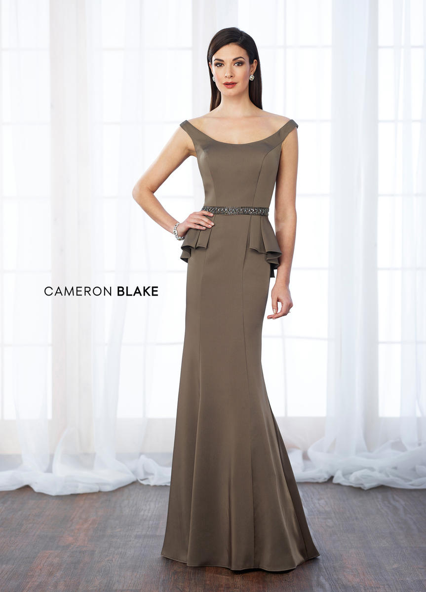 Boat neck floor length gown in crepe material. Beaded belt with wrap around back peplum.  ONLY 1 IN STOCK  DISCONTINUED STYLE