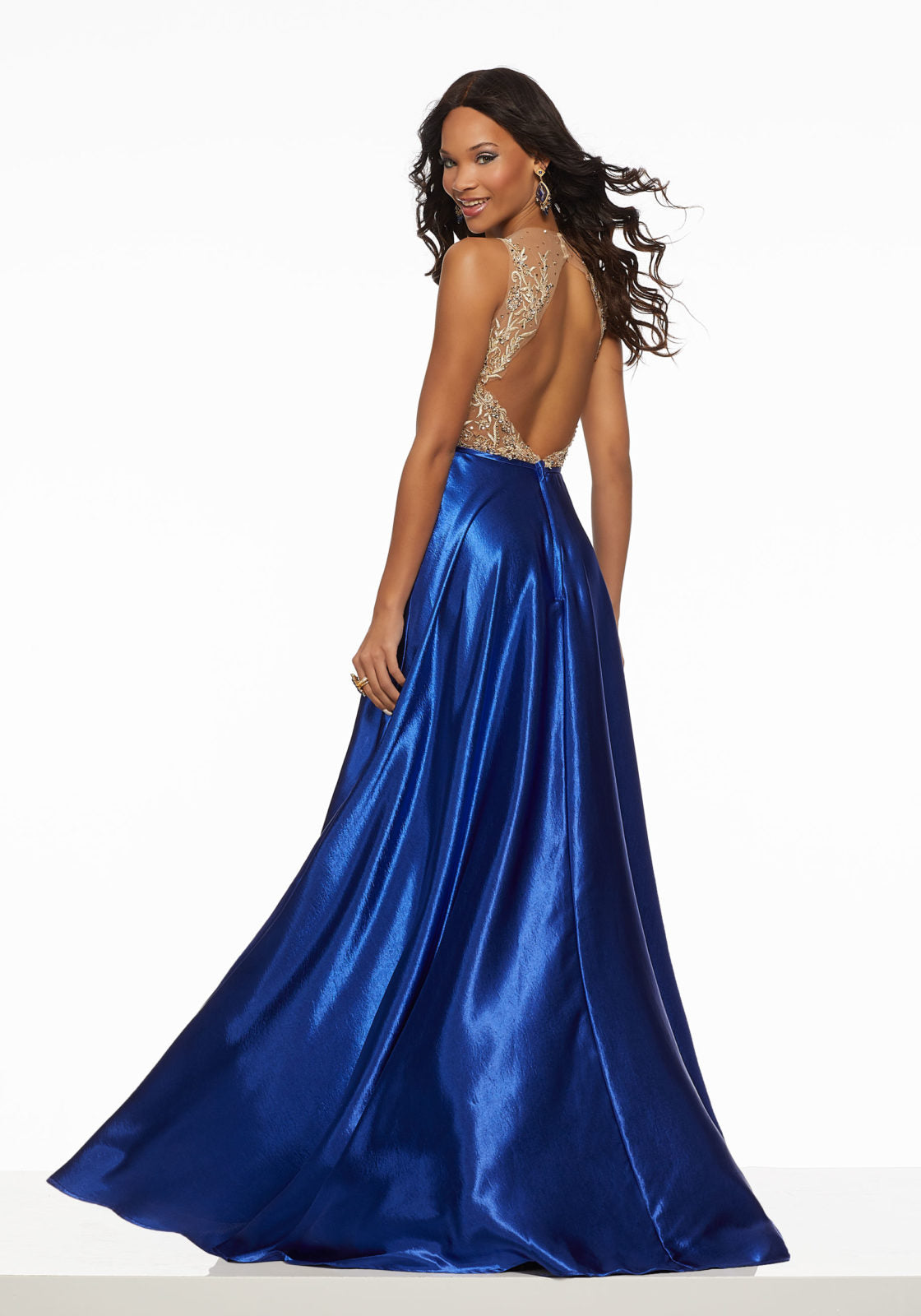 This designer prom dress features an illusion high neckline and an a-line silhouette. Available in royal and red, the natural waistline and beaded embroidery along the bodice compliment the hammered satin skirt. The open back completes the look of this designer prom dress.  Sizes: 00-24  Available in Red, Royal Blue  If we do not have your desired size or color in stock please call or email us for availability!