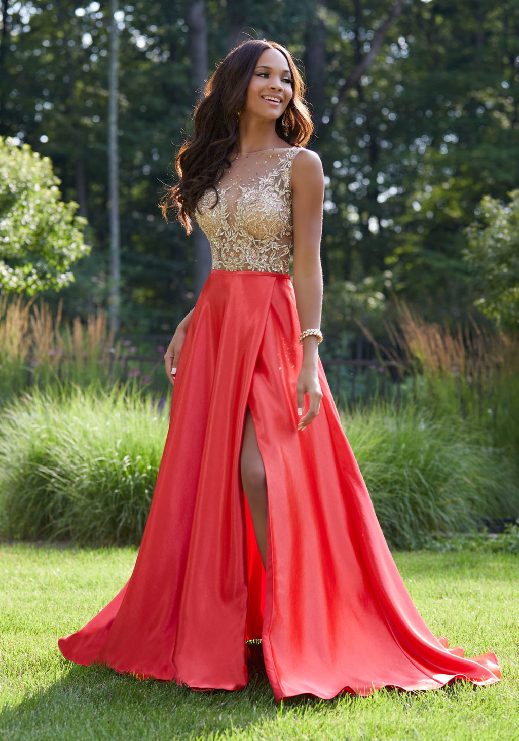 This designer prom dress features an illusion high neckline and an a-line silhouette. Available in royal and red, the natural waistline and beaded embroidery along the bodice compliment the hammered satin skirt. The open back completes the look of this designer prom dress.  Sizes: 00-24  Available in Red, Royal Blue  If we do not have your desired size or color in stock please call or email us for availability!