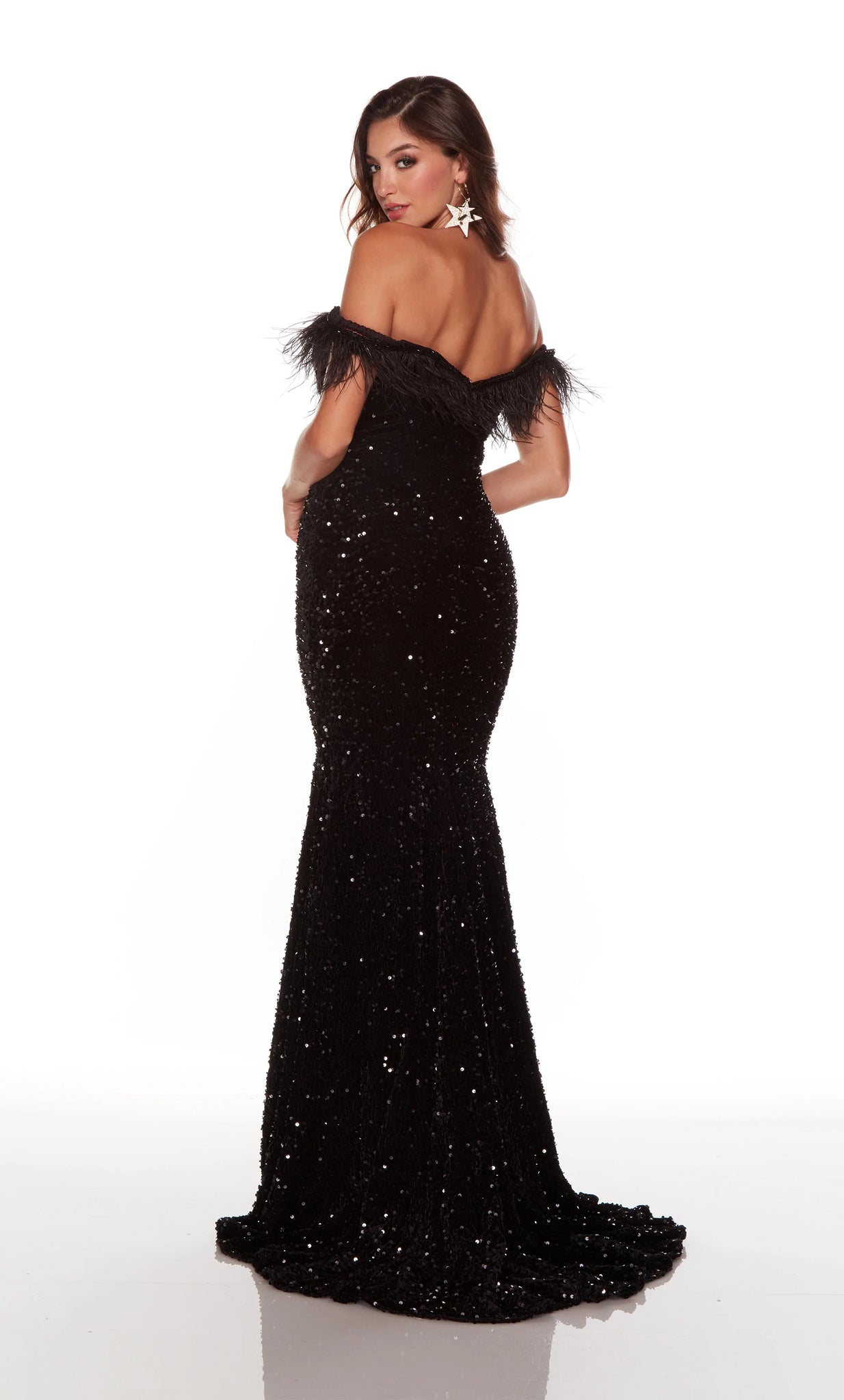 This Alyce Paris 61373 black long party dress is crafted in plush sequins, with ostrich feathers and beaded trims along the plunging off-the-shoulder neckline. This sparkly slim prom gown exits with a semi-open back and a sweep train.