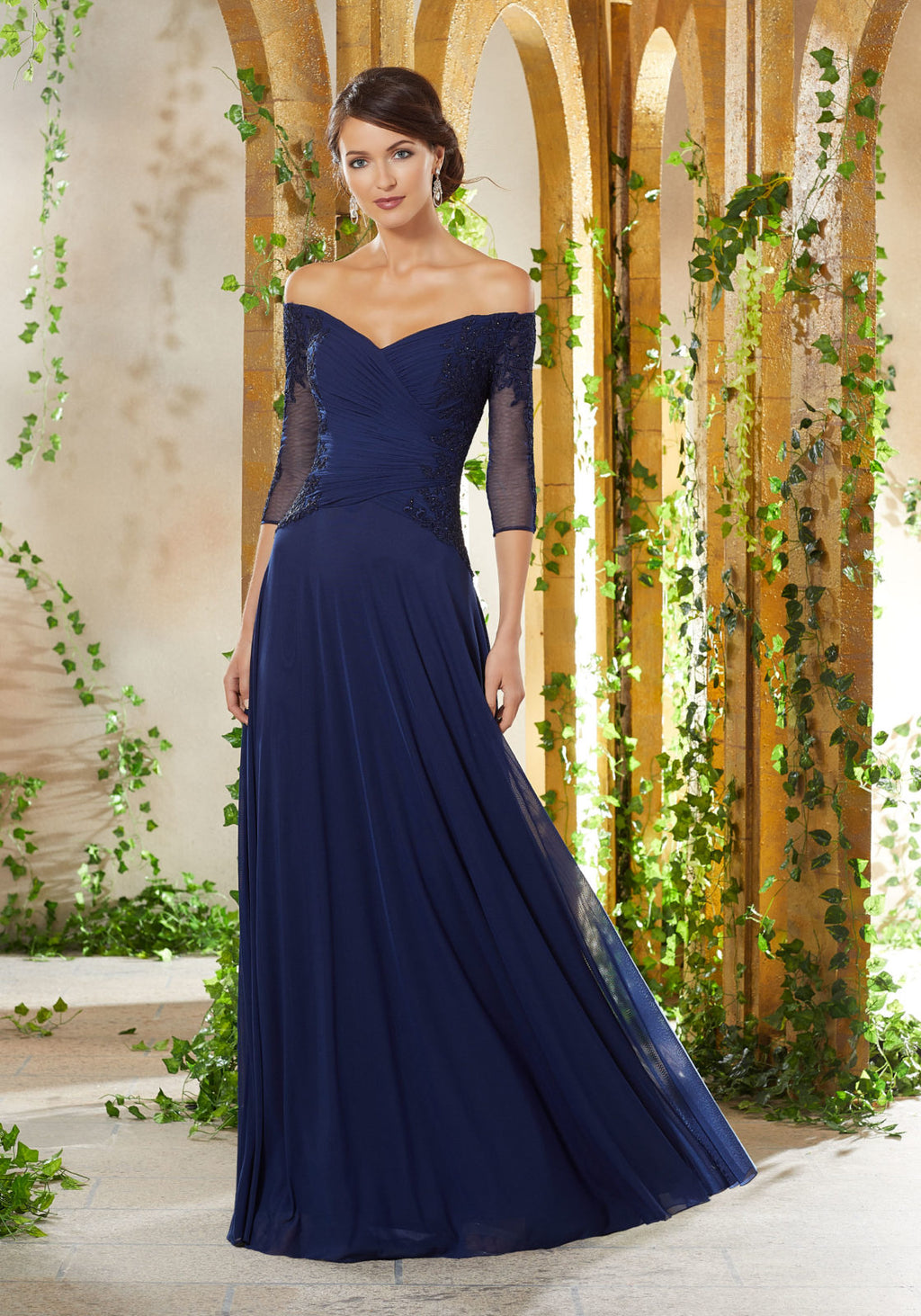 Three-Quarter sleeve stretch mesh evening gown, with an off the shoulder bodice accented in beaded lace appliqués.  Sizes: 2-24  Available in Navy, Rose  If we do not have your desired size or color in stock please call or email us for availability!