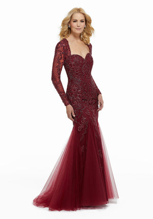 Tulle evening gown featuring allover beading with long sleeves and sweetheart neckline. Mermaid silhouette. **Picture not available in Charcoal**  Sizes: 2-24  Available in Charcoal, Black, Wine  If we do not have your desired size or color in stock please call or email us for availability!