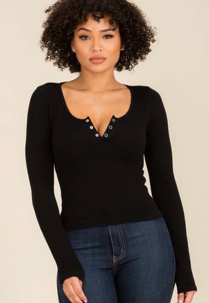 Stretchy comfy fabric with 3 buttons that can be worn snapped or unsnapped to create a V-neck.