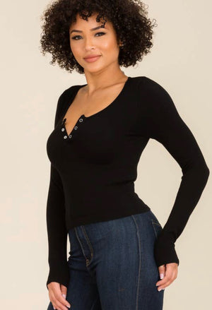 Stretchy comfy fabric with 3 buttons that can be worn snapped or unsnapped to create a V-neck.