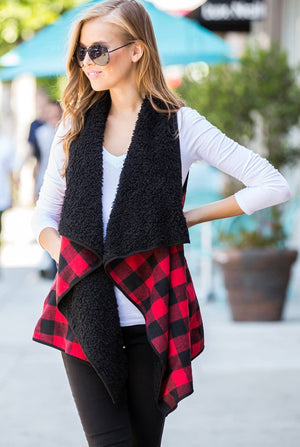 A beautiful vest that is super soft curly sherpa lined in black. Red Buffalo plaid on the outside with convenient pockets for storage!