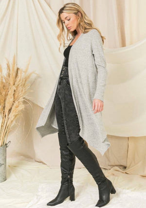 Crazy soft, long sleeve knit cardigan cover up. Open in front with asymmetrical cut hem.