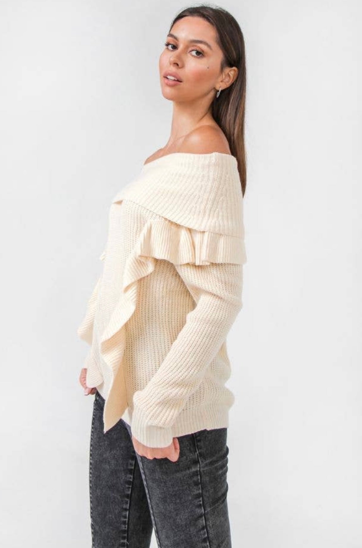 Off the shoulder knit sweater with ruffled accents.  cream in color