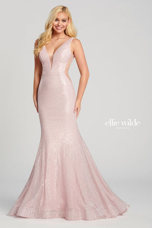 Sleeveless novelty sequin stretch fit and flare gown with a plunging V-neck, sheer insets on the sides, natural waist, open back, horsehair hem and a sweep train.  Sizes: 00-16  Available in Light Pink, Light Gold, Red  If we do not have your desired size or color in stock please call or email us for availability