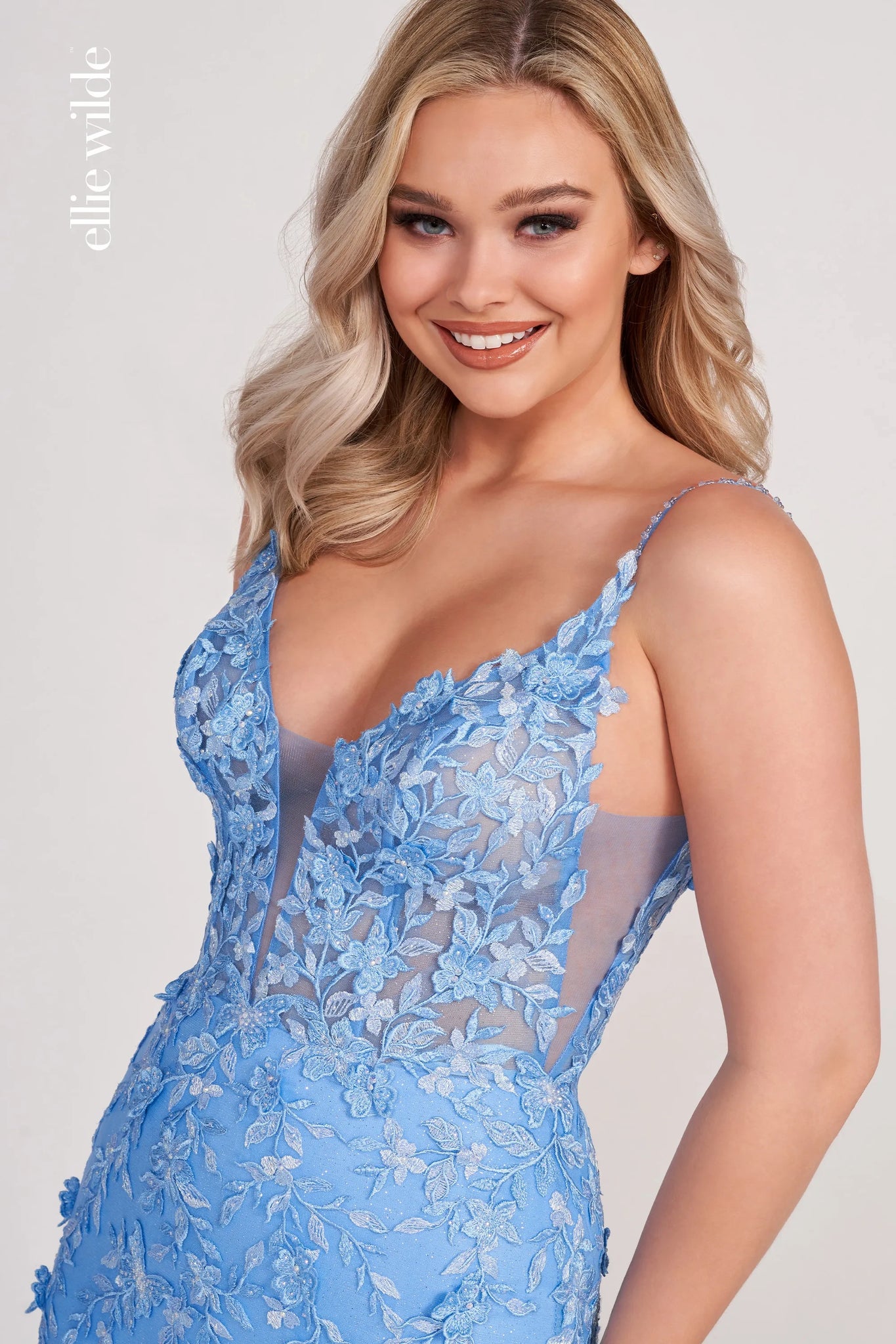 Embrace your celestial charm in this heavenly dress by Ellie Wilde. Designed with a mermaid silhouette, the dress is designed with a faux plunging neckline and a sheer corset bodice. The dress is embellished with beautiful flower appliques and gives the most heavenly elegance.