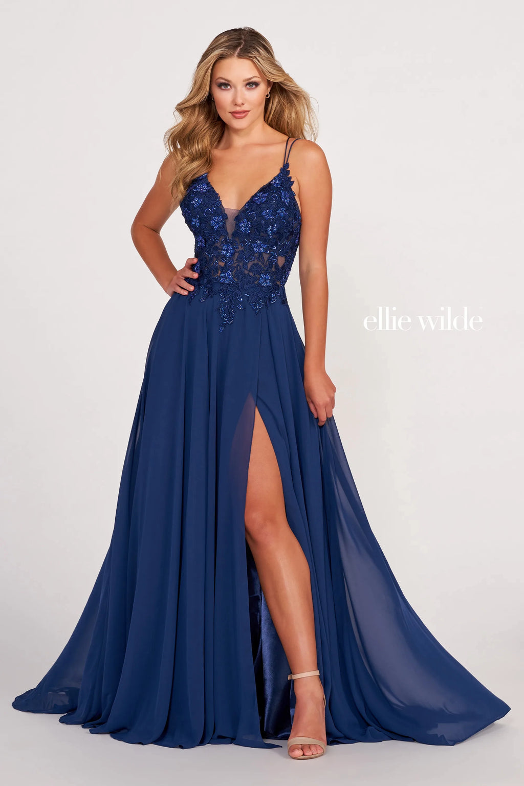 Looking for a show-stopping dress that will turn heads? Look no further than the Ellie Wilde EW34078. This gorgeous dress features intricate embroidered lace with three-dimensional flowers and stone accents. The flowing chiffon material is perfect for a night out on the town or a special event. You're sure to dazzle in this stunning dress!
