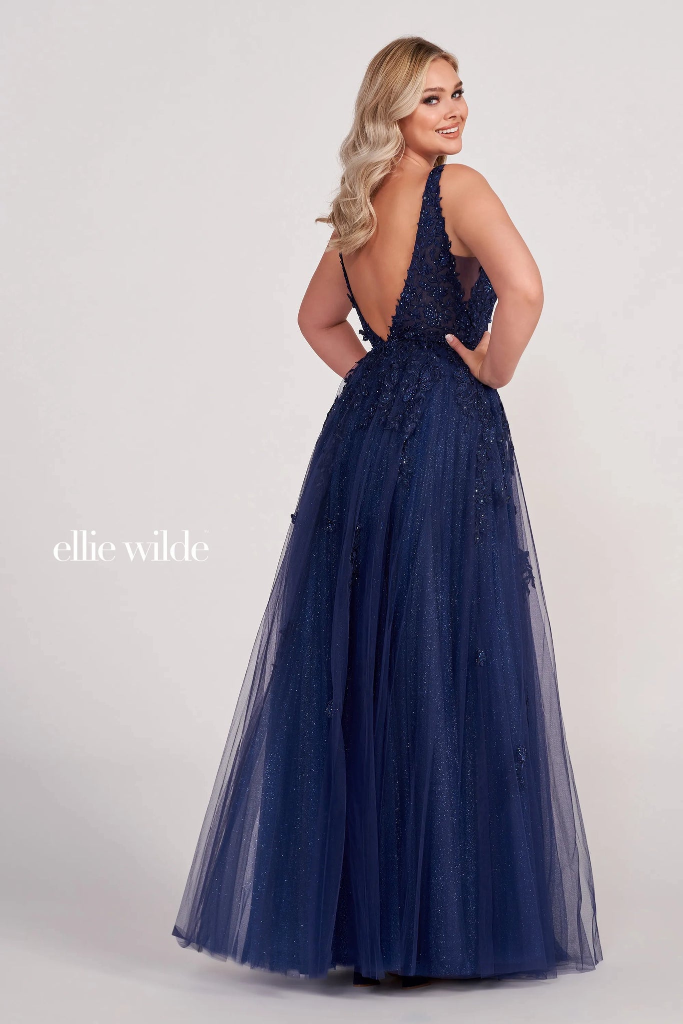  long party dress features a sleeveless A-line silhouette in glitter tulle, with a deep plunging neckline and an open V-back. Beaded lace appliques and 3D flowers richly embellished this pretty prom gown, finished with sheer side insets and a thigh-high slit.