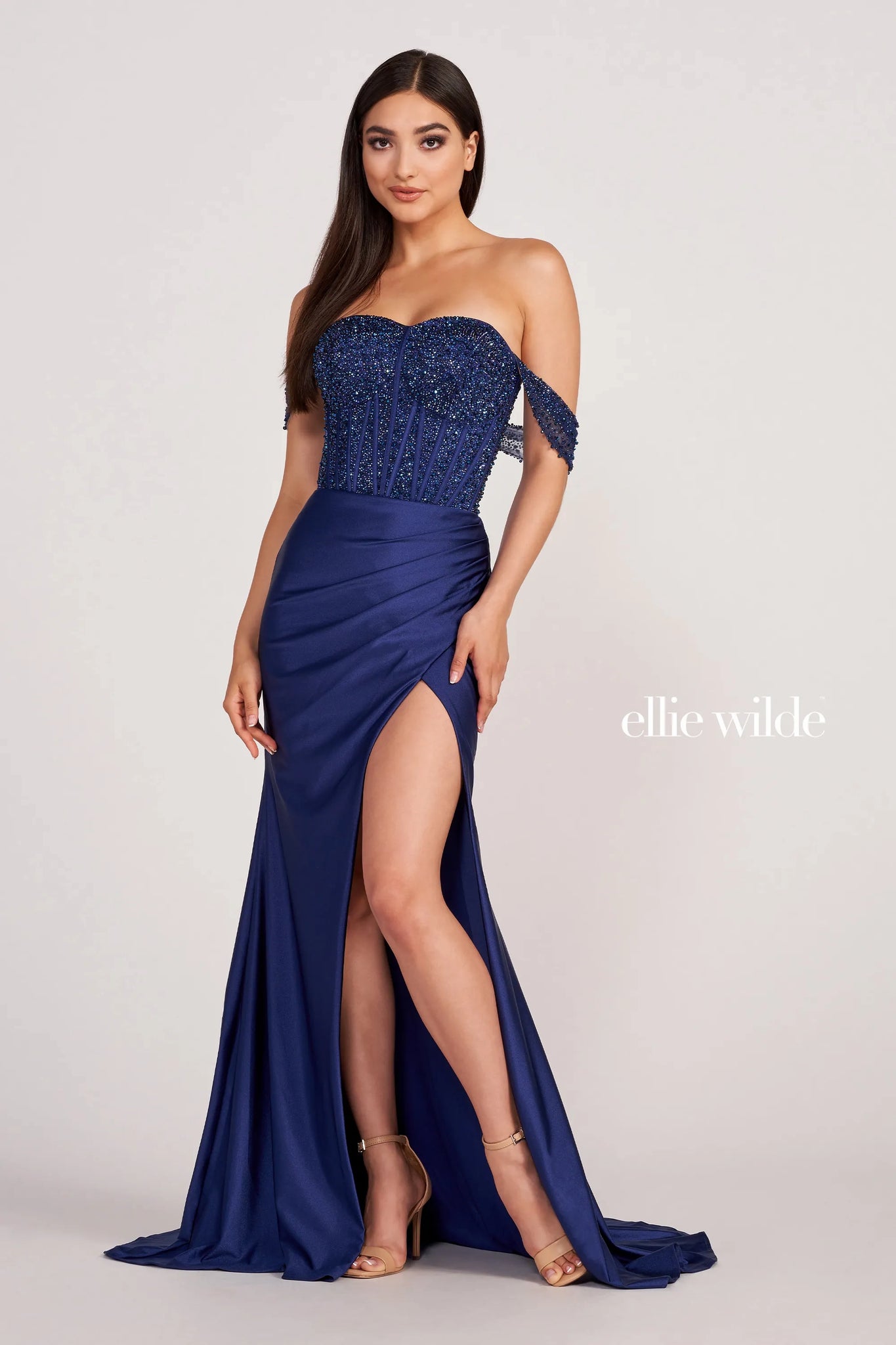 Instantly have all eyes on you in the long style EW34112 by Ellie Wilde. Showing off the flattering sweetheart neckline complimented with off the should cap sleeves. The corset is gorgeously adorned with hand sewn beading and along the skirt changes into a stretch novelty material to hug you effortlessly all night long.