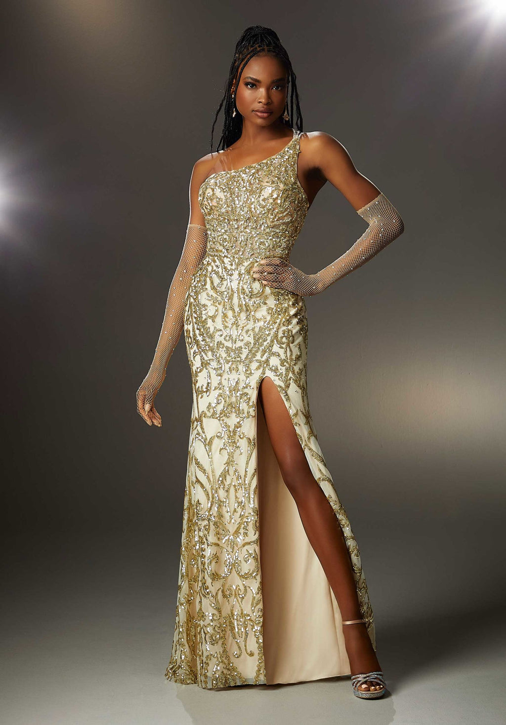 Have a major fashion moment in this amazing Morilee long fitted dress 47002. The neckline showcases scalloped details among the trim and the single shoulder branches into three thin beaded straps across your back. The bodice is made from a sheer illusion decked in a gorgeous pattern of sequins beadwork and travels down the long skirt. A front side slit and sweeping train add to the glam factor.