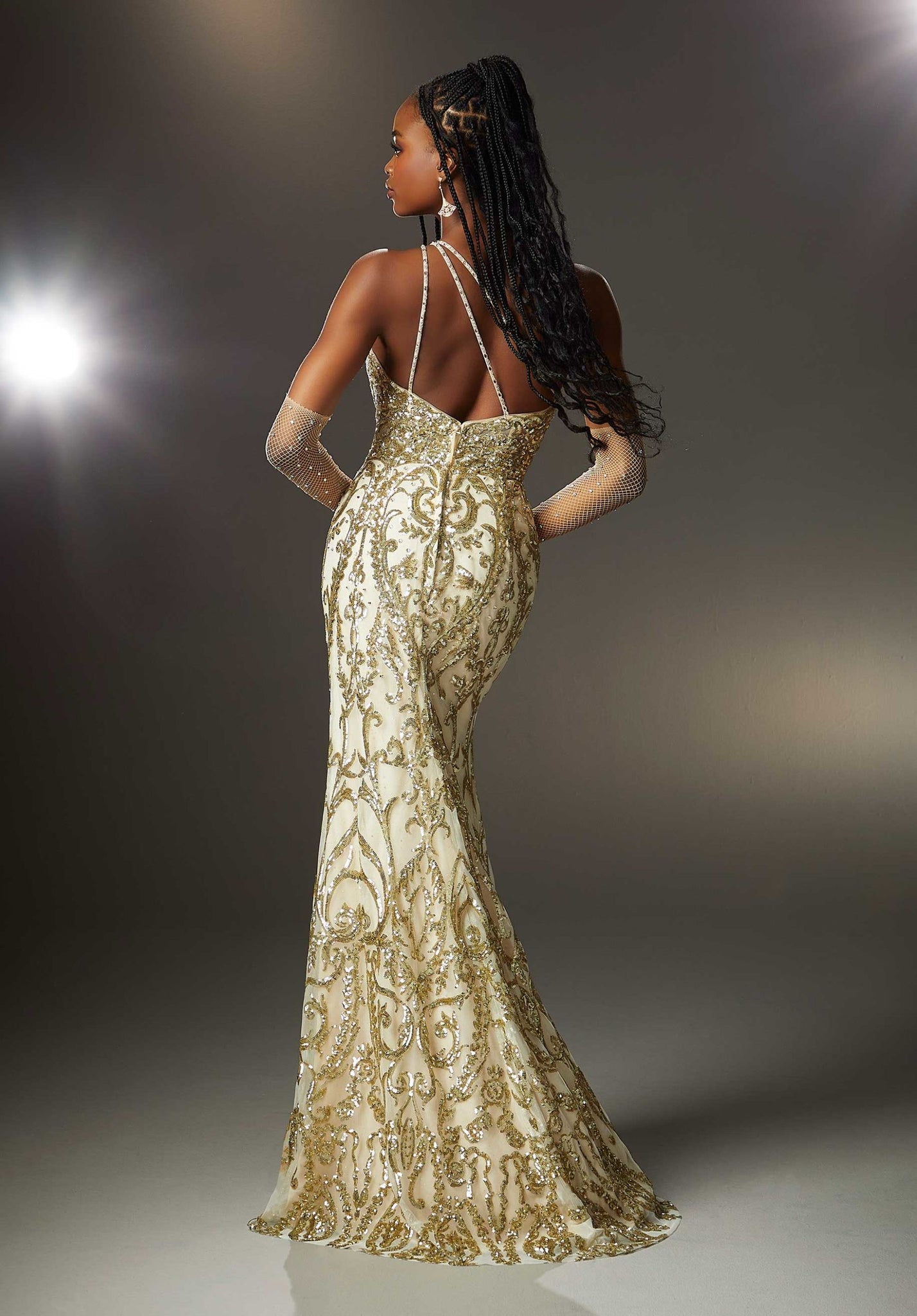 Have a major fashion moment in this amazing Morilee long fitted dress 47002. The neckline showcases scalloped details among the trim and the single shoulder branches into three thin beaded straps across your back. The bodice is made from a sheer illusion decked in a gorgeous pattern of sequins beadwork and travels down the long skirt. A front side slit and sweeping train add to the glam factor.