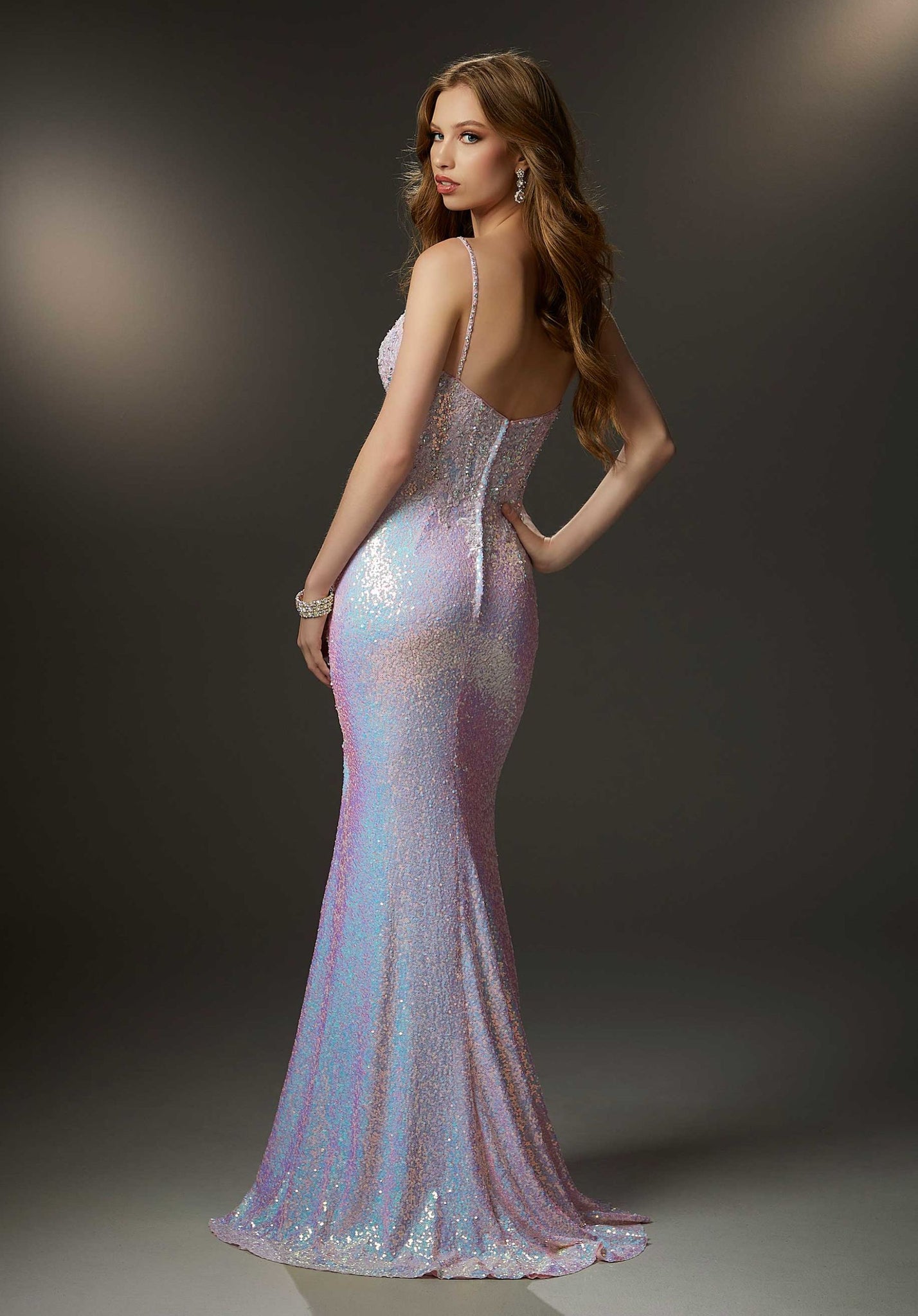 Glamorous prom dress in glistening allover sequin fabric with a chic boned v-neck bodice featuring blingy crystal beaded embroidery and a sultry skirt slit.