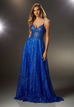 Classic A-line prom dress features a sheer deep-v bodice and flowing skirt designed with sparkling patterned glitter and blingy beaded trim. The spaghetti straps cross in the back meeting up with the lace-up corset back.