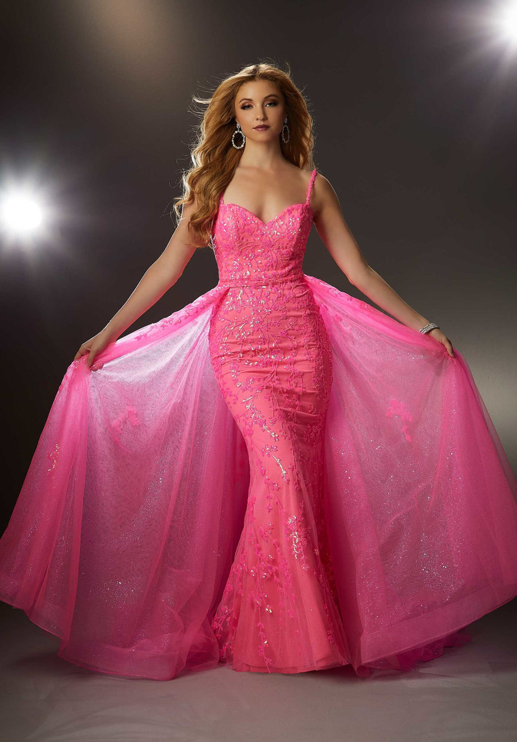 Bright prom dress with botanical-inspired patterned sequin over glimmering sparkle net with a sweetheart neckline on a sultry fit and flare silhouette. Add on the detachable overskirt for extra drama.